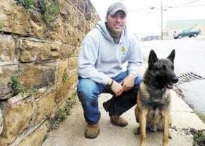 Det. Craig Capps proudly shows off his new K-9 partner Taro, who he purchased through his own fundraising efforts. Taro will be on patrol beginning March 4.